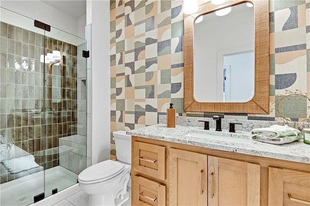 bathroom featuring vanity, toilet, tile patterned floors, and a shower with door