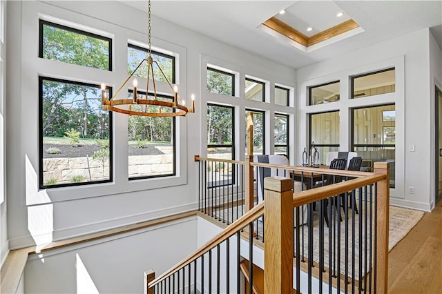 25110 W 98th Pl, Lenexa, KS 66227 - hall featuring a chandelier, an upstairs landing, healthy amount of natural light, a high ceiling, and a raised ceiling