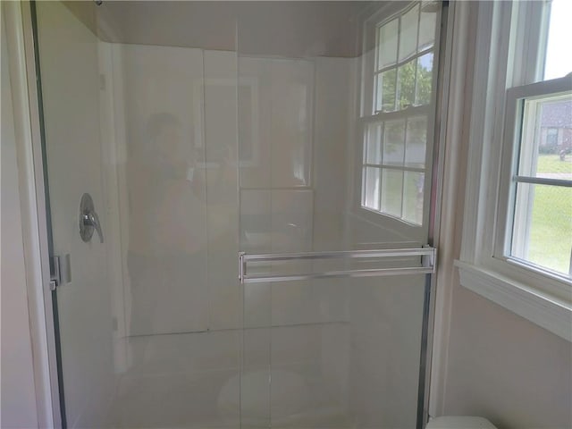 full bath featuring a shower stall and a healthy amount of sunlight