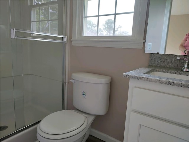 bathroom featuring walk in shower, vanity, and toilet