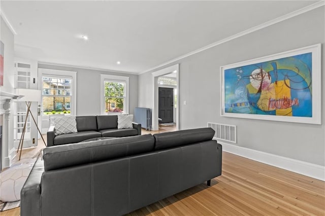 living room featuring hardwood / wood-style flooring and crown molding