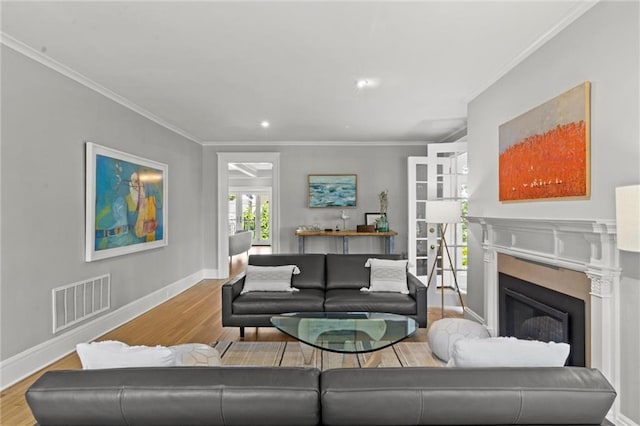 living room with light hardwood / wood-style flooring and ornamental molding