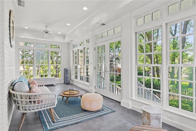 sunroom featuring ceiling fan