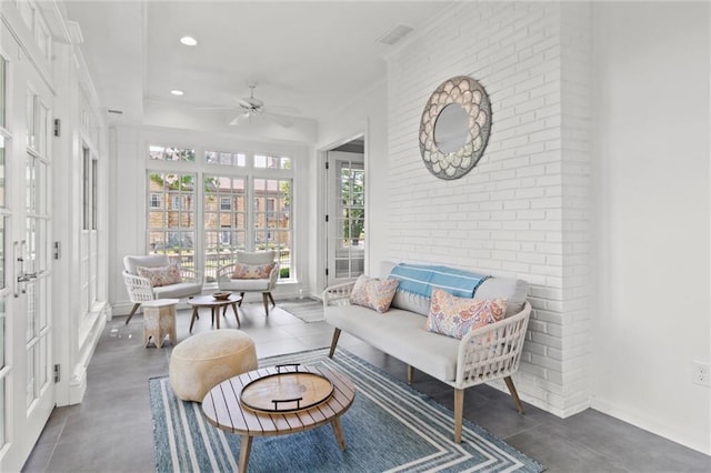 sunroom / solarium with ceiling fan and french doors