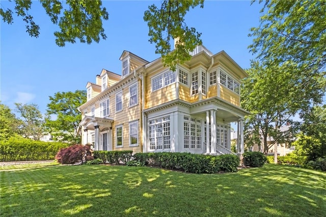 view of property exterior with a lawn