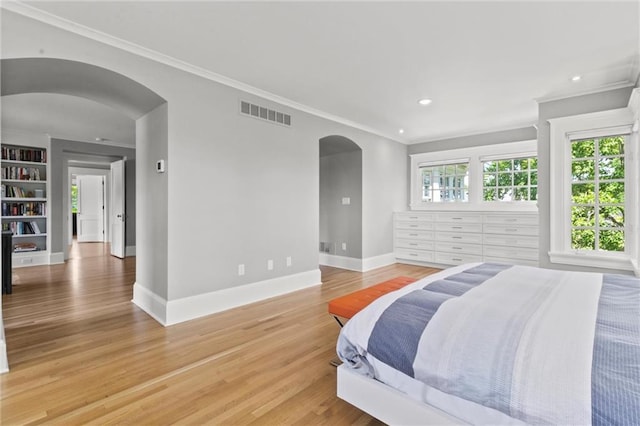 bedroom with crown molding and hardwood / wood-style flooring