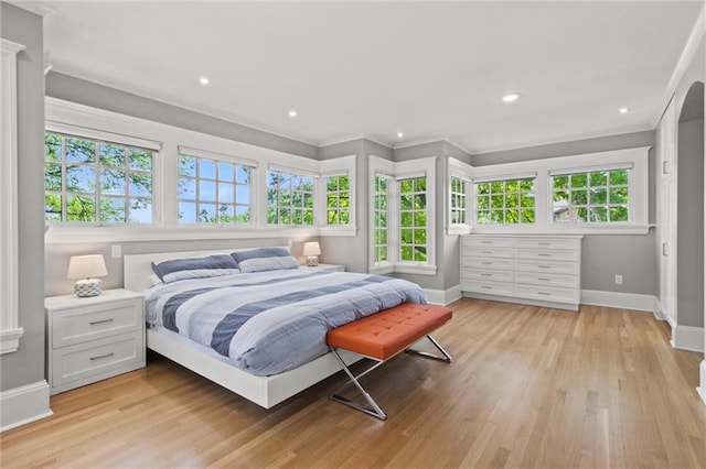 bedroom featuring light hardwood / wood-style flooring and crown molding