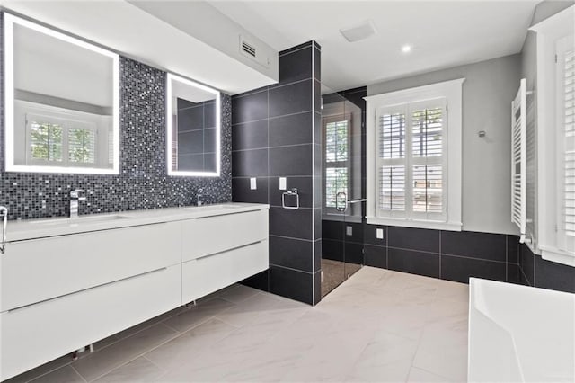 bathroom featuring tile patterned floors, a shower, and vanity