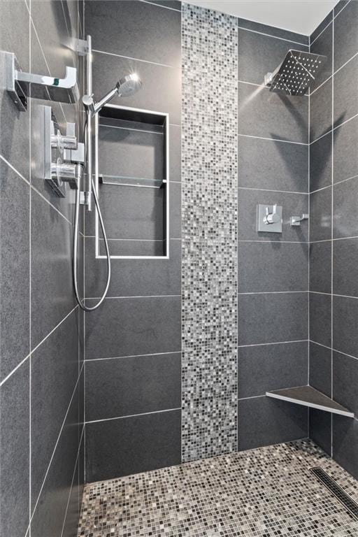 bathroom with tiled shower