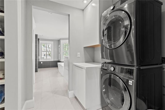 laundry room featuring stacked washer / dryer