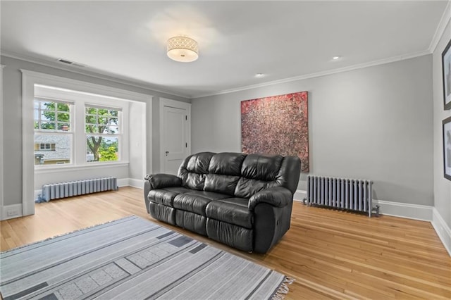 living room featuring radiator, crown molding, and wood-type flooring