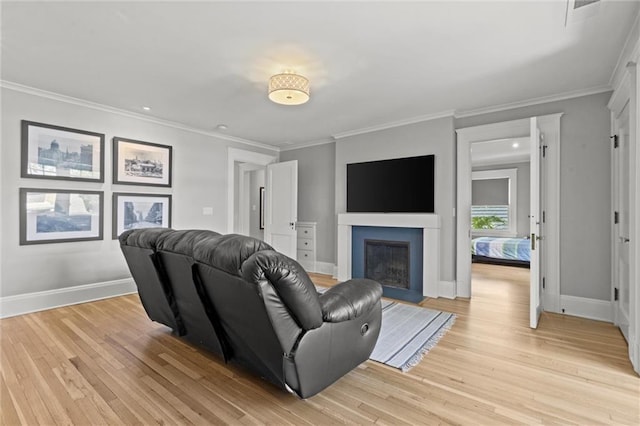 living room with light hardwood / wood-style floors and ornamental molding