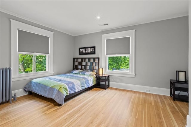 bedroom featuring radiator and light wood-type flooring