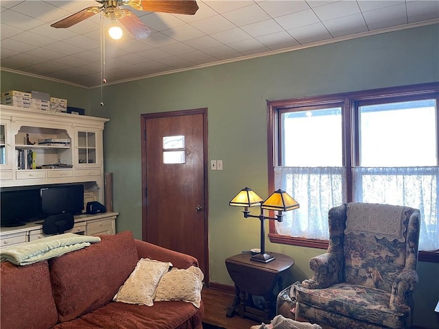 living room featuring ornamental molding and ceiling fan