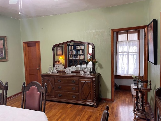 interior space featuring baseboards and wood finished floors