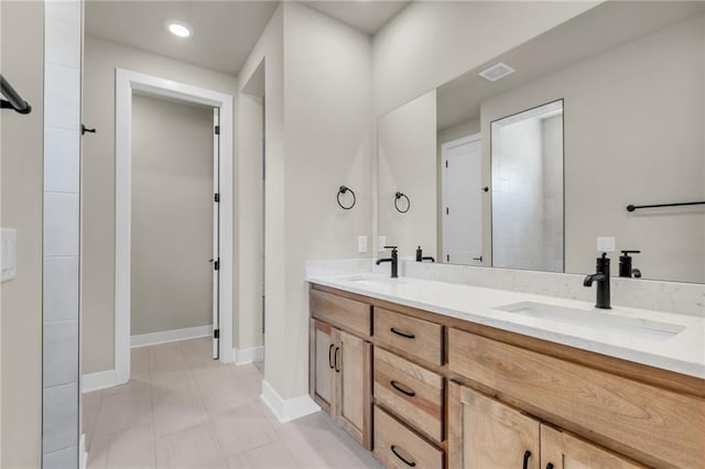 bathroom featuring tile patterned flooring and vanity