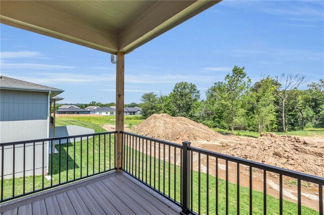 wooden deck featuring a lawn