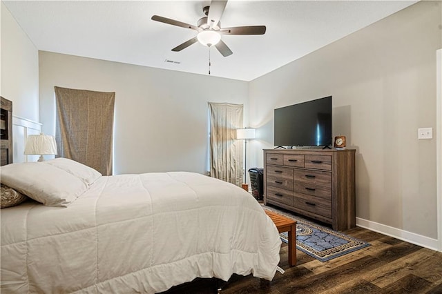 bedroom with ceiling fan and dark hardwood / wood-style flooring