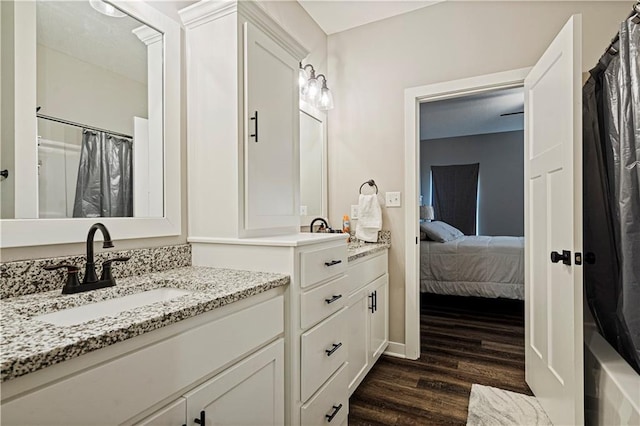 bathroom featuring walk in shower, vanity, and hardwood / wood-style flooring