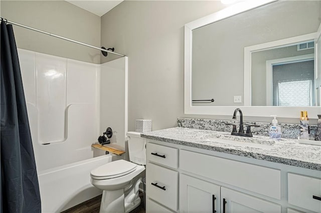 full bathroom with shower / bathtub combination with curtain, hardwood / wood-style floors, vanity, and toilet