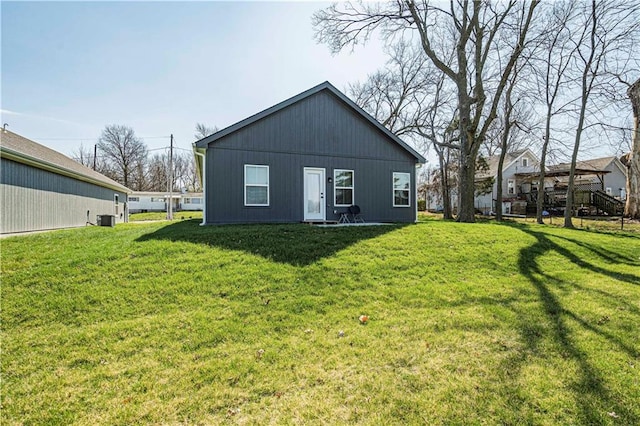 rear view of house featuring a yard