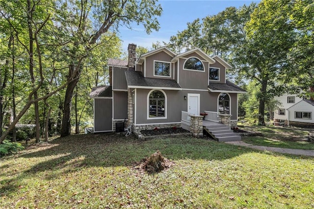 view of front property with a front lawn and central AC unit