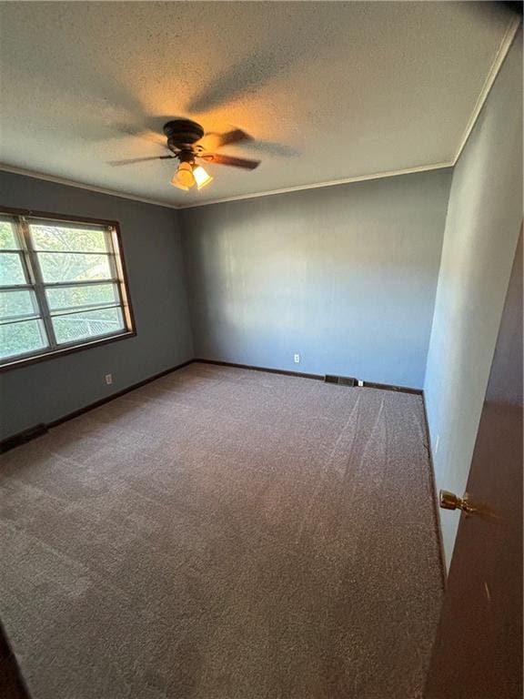 carpeted empty room with a textured ceiling, ornamental molding, and ceiling fan