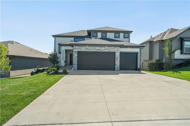 view of front of property featuring a garage and a front lawn