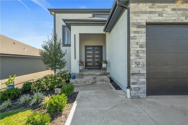 doorway to property with a garage