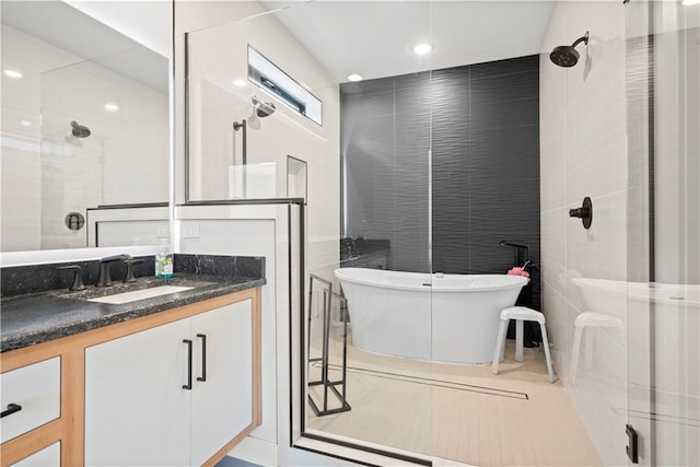 bathroom with independent shower and bath, vanity, tile walls, and tile patterned floors