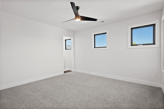 empty room featuring carpet and ceiling fan