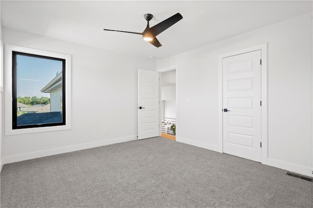 unfurnished bedroom featuring ceiling fan and carpet flooring