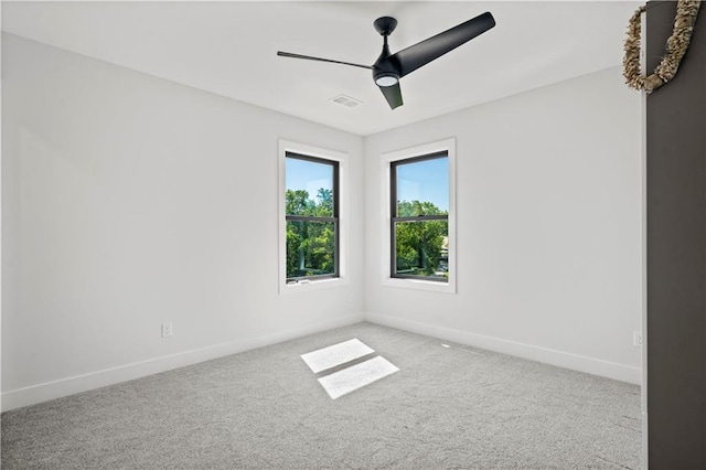 carpeted empty room featuring ceiling fan