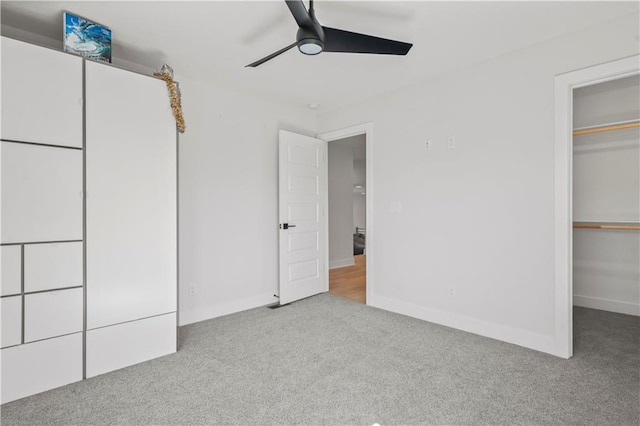 unfurnished bedroom with ceiling fan and light colored carpet