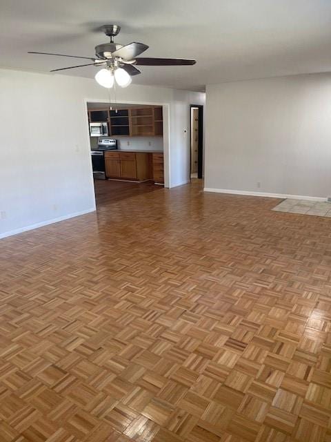 unfurnished living room with ceiling fan and light parquet floors