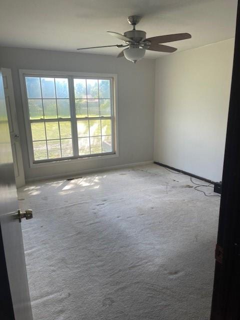 carpeted empty room with ceiling fan