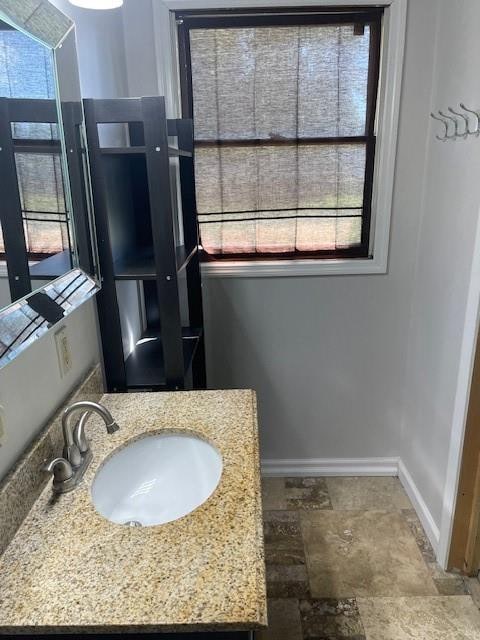 bathroom featuring a wealth of natural light and sink