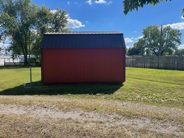 view of outbuilding with a yard