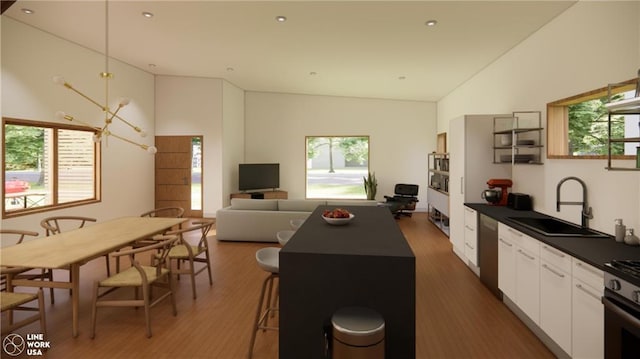 kitchen with dark wood-type flooring, white cabinets, a kitchen island, stainless steel appliances, and sink