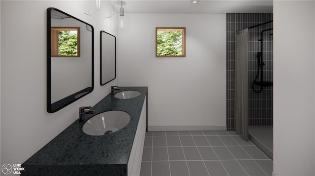 bathroom featuring a healthy amount of sunlight, tiled shower, and vanity