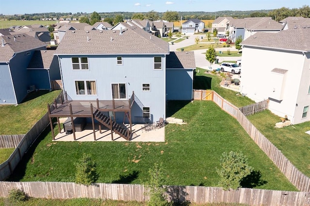 rear view of property featuring a yard and a patio area