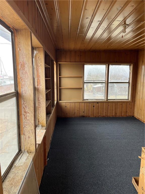 unfurnished sunroom with wood ceiling