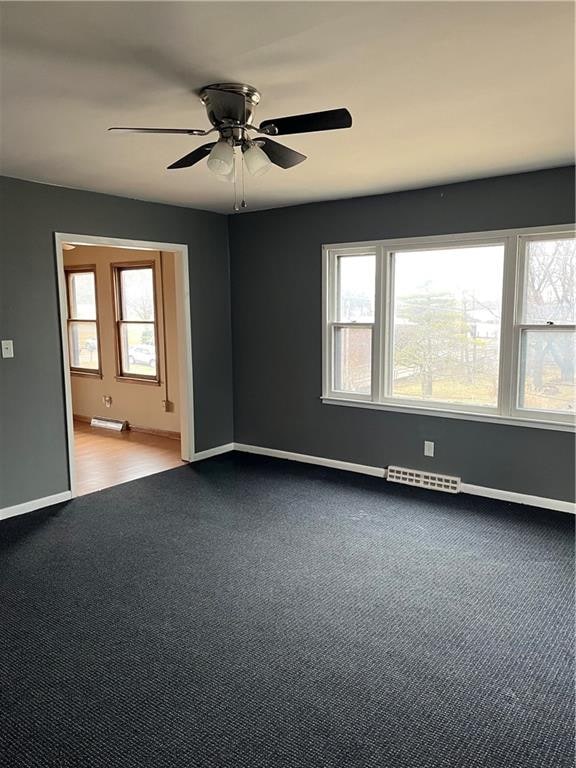 carpeted empty room with ceiling fan