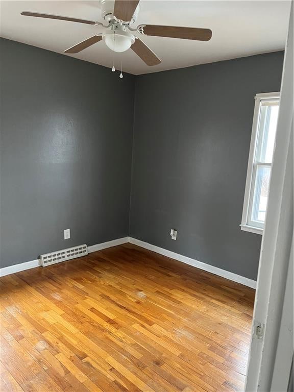 spare room featuring light hardwood / wood-style flooring and ceiling fan