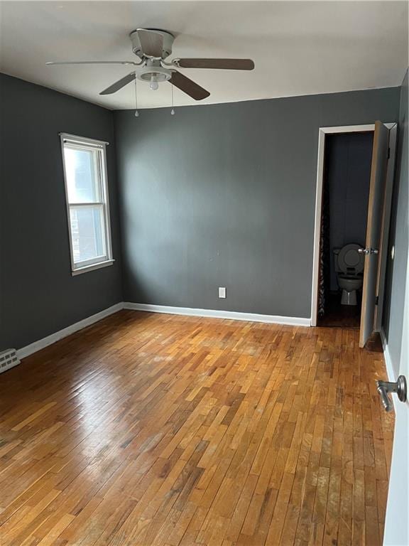 empty room with light hardwood / wood-style floors and ceiling fan