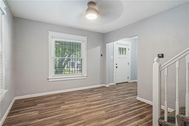 foyer featuring ceiling fan and dark wood-type flooring