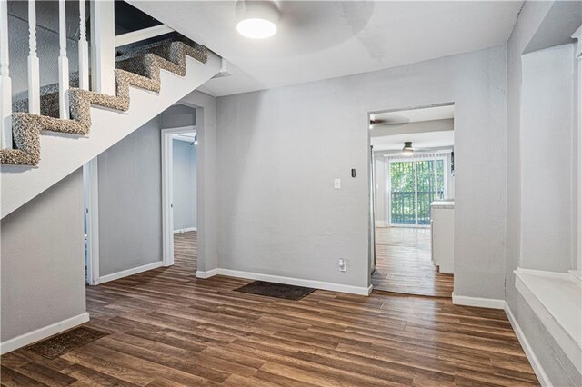 interior space featuring ceiling fan and dark hardwood / wood-style floors