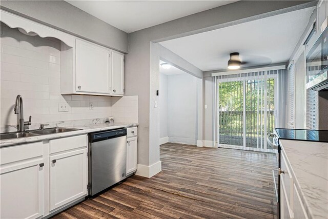 kitchen with stainless steel appliances, white cabinetry, dark wood-type flooring, and sink