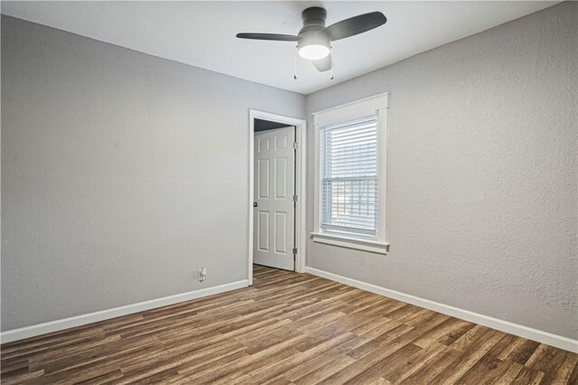 empty room featuring hardwood / wood-style floors and ceiling fan