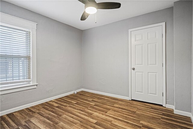 spare room with wood-type flooring and ceiling fan